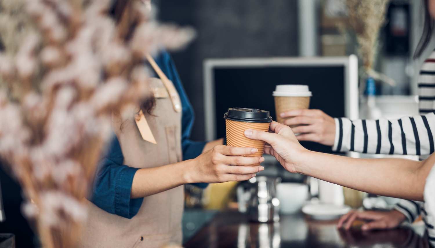 a person holding a cup of coffee