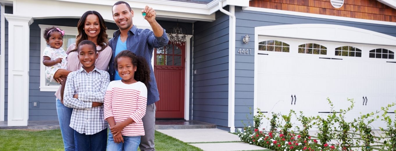 a group of people standing in front of a house